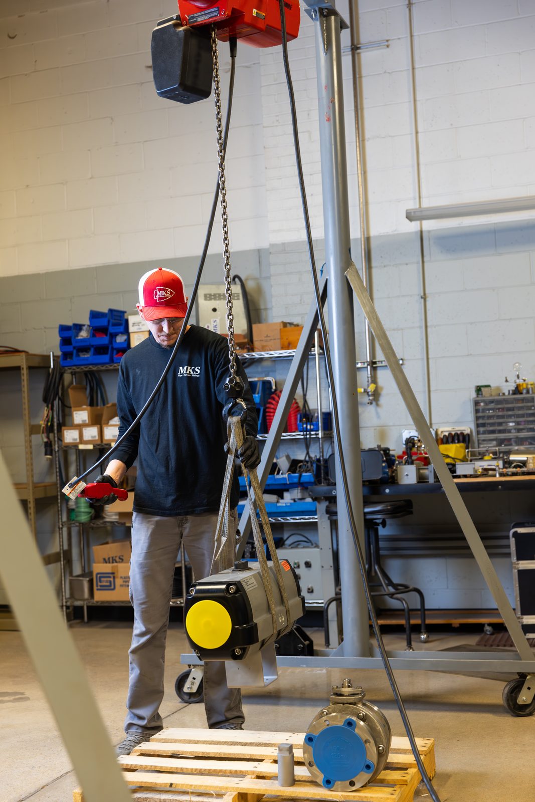 MKS technician operating equipment in the machine shop